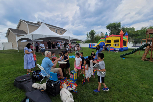 small - outdoor birthday party with tent and bounce house